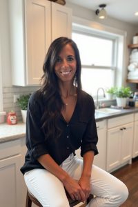 Priscilla Lowe sitting in a kitchen.